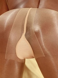 Slim ebony girl in shiny pantyhose on the bed image 5
